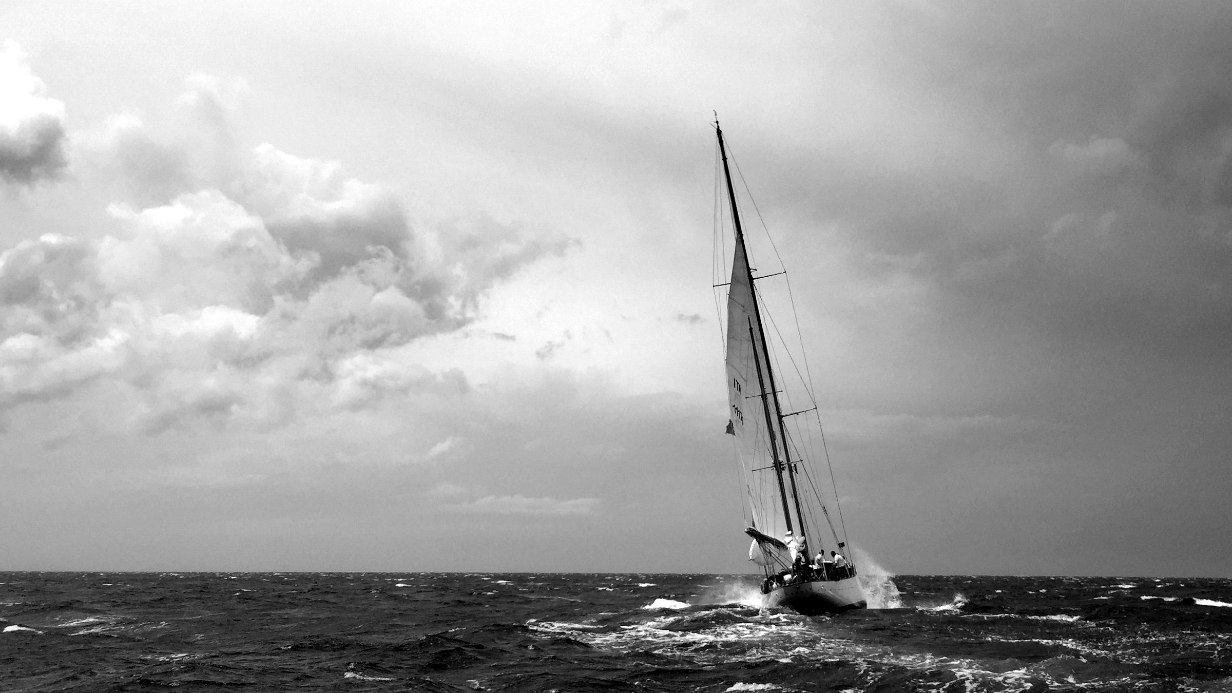 A sailboat holding its course in a storm